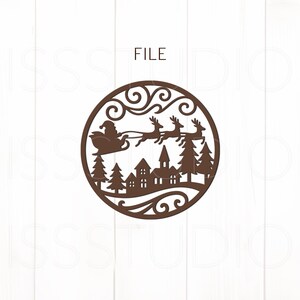 May include: A brown circular Christmas ornament featuring Santa Claus in a sleigh pulled by reindeer, flying over a village with trees. The word "FILE" is at the top.