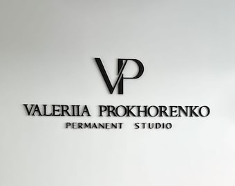 May include: Black and white logo on a white wall. The logo is a stylized "VP" with the text "VALERIYA PROKHORENKO PERMANENT STUDIO" below it.