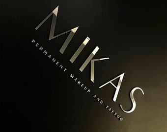 May include: Silver Mikas logo on a black background. The text reads "Mikas Permanent Makeup and Tattoo".
