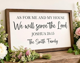May include: A rectangular wooden sign with a dark brown frame and a white background. The text reads: AS FOR ME AND MY HOUSE, We will serve the Lord, JOSHUA 24:15, The Smith Family. The lettering is black, featuring a mix of serif and script fonts.