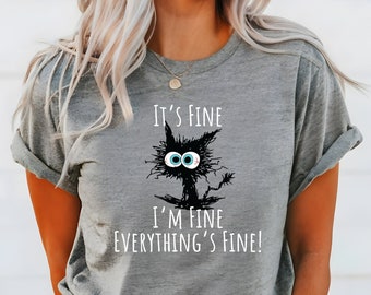 Könnte beinhalten: Graues T-Shirt mit einer schwarzen Katzenillustration und dem Text "Es ist gut, mir geht es gut, alles ist gut!"