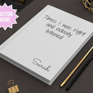 May include: White notebook with the text "Times I was right and nobody listened" and the name "Sarah" written on the cover.