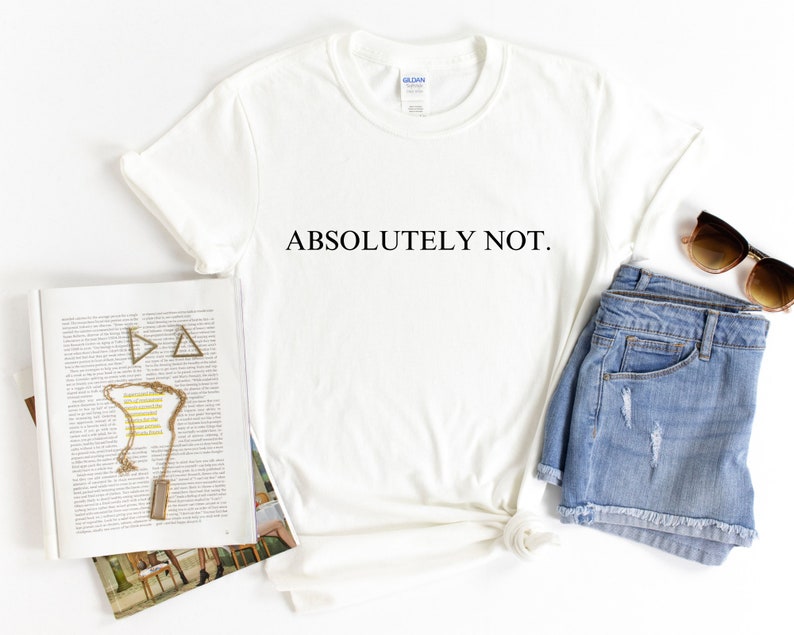 May include: White t-shirt with the text "ABSOLUTELY NOT." printed in black on the front. The shirt is styled with denim shorts and sunglasses.