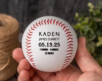 May include: White baseball with red stitching, personalized with the name "Kaden James Durrett", birthdate "05.13.25", weight "7 pounds 8 ounces", and length "22 inches".