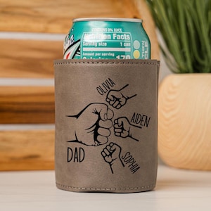 May include: A brown leather can cooler with a design of four fists bumping each other. The names "DAD", "OLIVIA", "AIDEN", and "SOPHIA" are written around the fists.