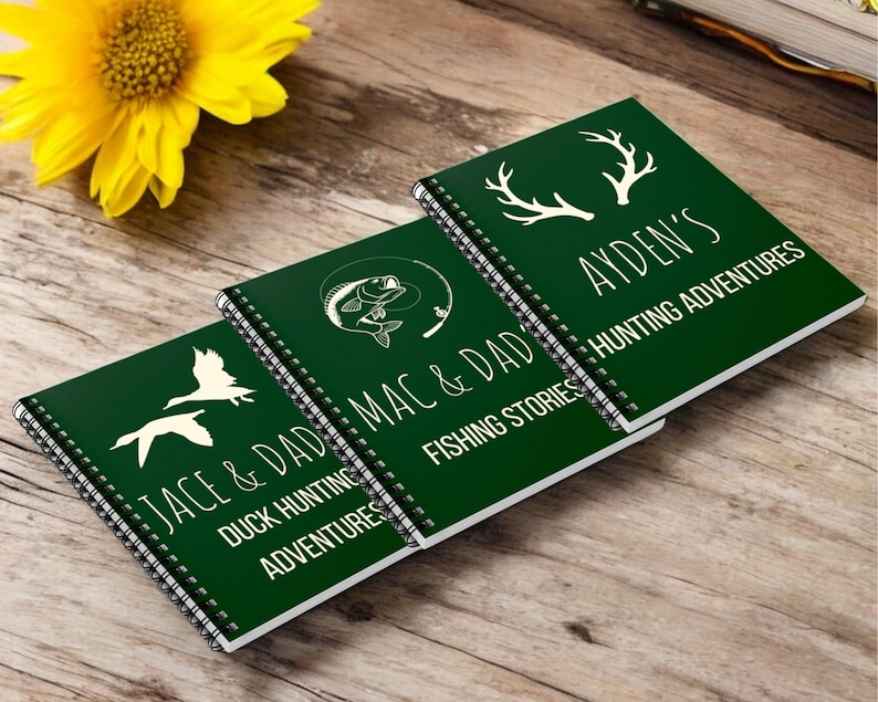 May include: Three green spiral bound journals with white text and illustrations. The journals are titled "Jace & Dad Mac & Dad Duck Hunting Adventures", "Jace & Dad Mac & Dad Fishing Stories", and "Ayden's Hunting Adventures".