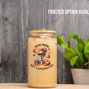 May include: A clear glass jar with a bamboo lid and a straw. The jar has a design of a skeleton holding a cup of coffee with the text "Dead Inside But Caffeinated" and fall-themed imagery.