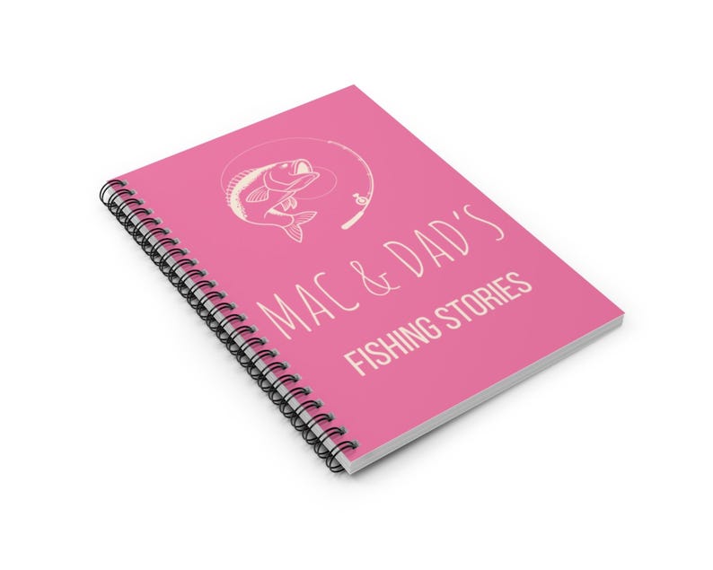 May include: Pink spiral bound notebook with a white illustration of a fish on a fishing line and the text "Mac & Dad's Fishing Stories".