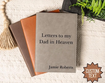 Op de afbeelding: Drie grijze, bruine en oranje lederen dagboeken met de tekst "Letters to my Dad in Heaven" en "Jamie Roberts" op de voorkant van het grijze dagboek.