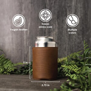 May include: Brown vegan leather can cooler with a 5 inch height and 3.75 inch diameter. The cooler is designed to keep drinks cold.