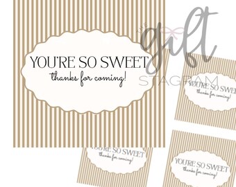 May include: A set of thank you tags with a striped background in beige and white. Each tag has an oval shape with the text "YOU'RE SO SWEET thanks for coming!" in black script.