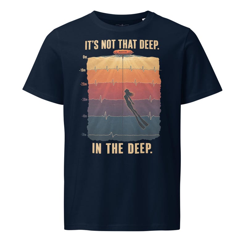 May include: A navy blue short-sleeve t-shirt featuring a graphic of a diver underwater with a depth gauge from 0m to 50m, an EKG heart rhythm line, and the text "IT'S NOT THAT DEEP. IN THE DEEP." printed in a light cream color on the front.