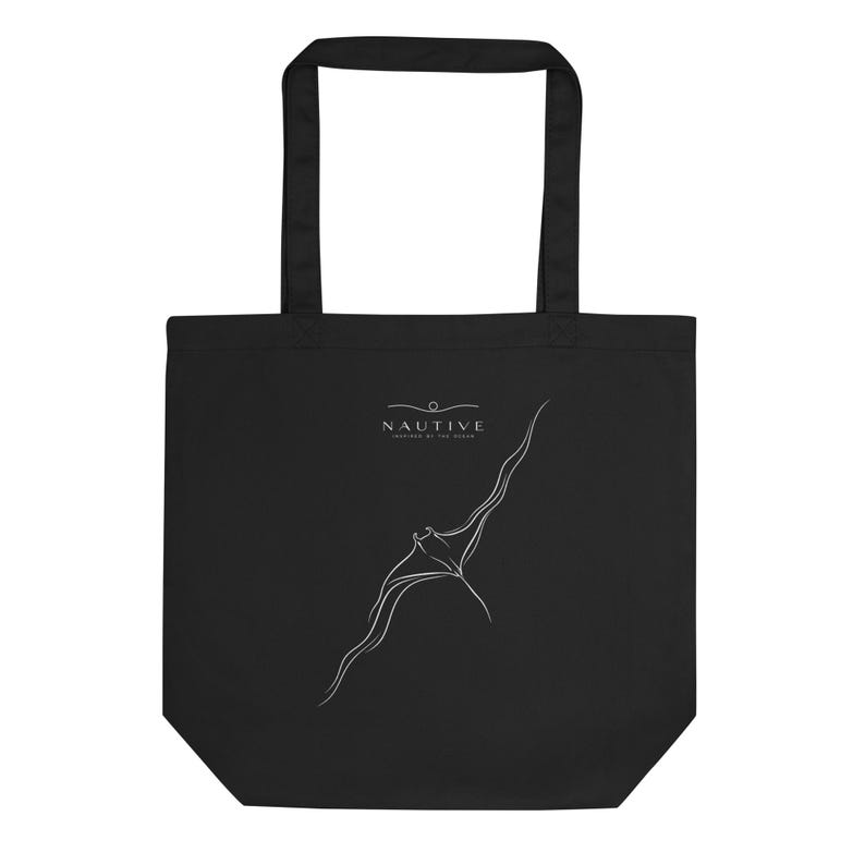 May include: A black tote bag featuring a white line art illustration of a manta ray swimming. Above the manta ray, the text NAUTIVE is printed in white, with the smaller text INSPIRED BY THE OCEAN positioned directly underneath the brand name.