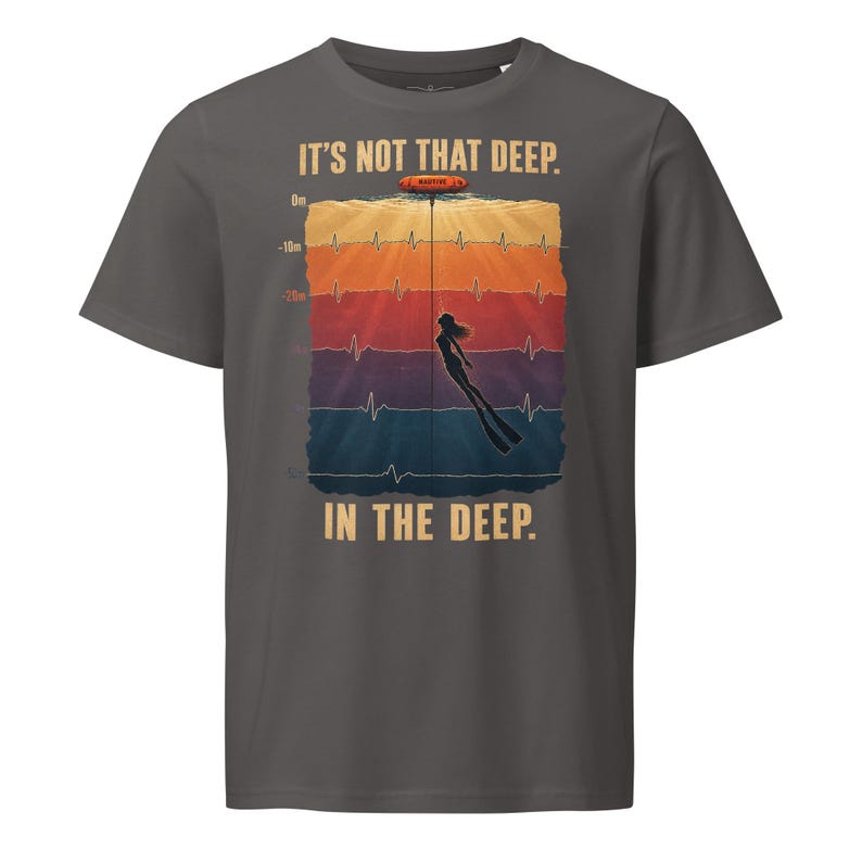 May include: A charcoal gray t-shirt featuring a graphic of a diver underwater with a heart rate monitor line. The text reads IT'S NOT THAT DEEP. IN THE DEEP. The design includes depth markers from 0m to 50m in a colorful, layered background.