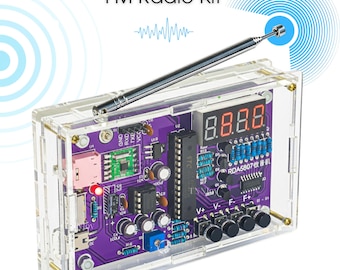 May include: A clear acrylic FM Radio Kit with a purple circuit board. The kit features a digital display, multiple buttons, and an antenna. The text "FM Radio Kit" is at the top. The kit is designed for DIY electronics projects.
