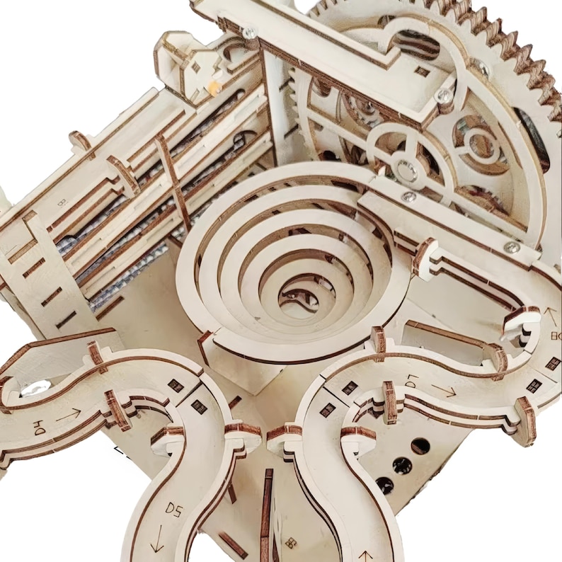 May include: A wooden marble run kit with a complex design. The kit features a series of tracks, spirals, gears, and ramps. The natural wood color of the pieces creates a visually appealing and engaging construction toy.