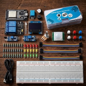 May include: An ESP32 Basic Starter Kit containing a microcontroller board, a two-relay module, an OLED display, a PIR motion sensor, a breadboard, jumper wires, resistors, LEDs, push buttons, a potentiometer, and a buzzer in a clear plastic case.