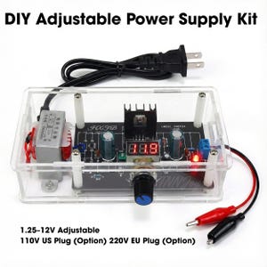 May include: DIY adjustable power supply kit in a clear acrylic case. The kit features a digital display, a black knob, and various electronic components. Includes a black power cord with a US plug and red and black alligator clips.