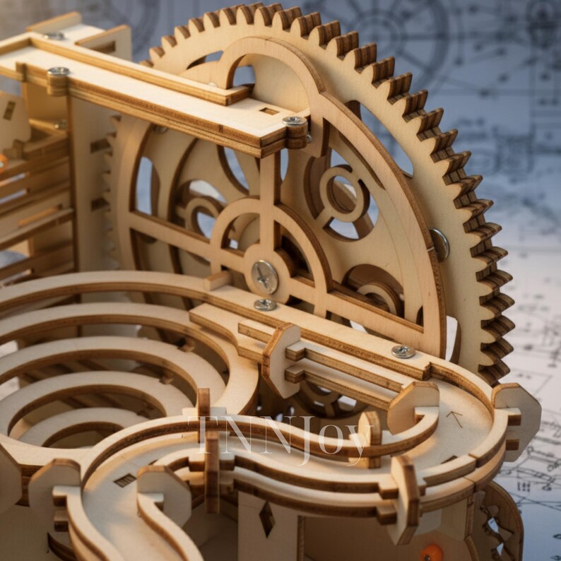 May include: A wooden marble run kit with intricate gears, tracks, and structural supports. The unfinished wood construction features a large gear wheel and curved pathways for the marbles. The design includes a complex system of interlocking pieces.