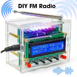May include: A DIY FM radio kit in a clear acrylic case. The radio features a circuit board with electronic components, a digital display showing "STEREO RADIO" and "FM: 87.0", and an antenna. The text "DIY FM Radio" is at the top.