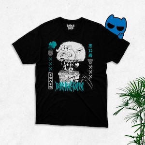 May include: Black t-shirt with a white graphic print of a robot head with the text "DRIVE THE PAIN" in blue. The text "BARKAI SHOP" is printed in white on the top left corner of the shirt. The text "愛してる" is printed in white on the right side of the shirt.