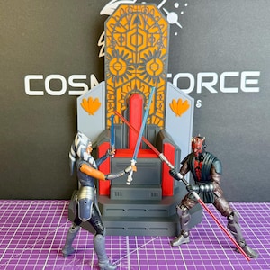 May include: Action figures of Ahsoka Tano and Darth Maul engaged in a lightsaber duel in front of a throne. The throne is gray, orange, and gold. The background has the text "COSMOS FORCE". The figures are on a purple grid.