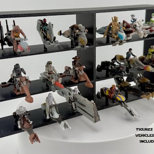 Może przedstawiać: Czarna półka ekspozycyjna z wieloma przegródkami, prezentująca różne miniaturowe pojazdy i figurki. Półka jest wypełniona kolorowymi zabawkami i postaciami, tworząc dynamiczny i atrakcyjny wizualnie układ. Tekst na dole: FIGURKI I POJAZDY NIE SĄ DOŁĄCZONE.