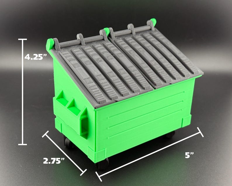 May include: A green plastic toy dumpster with a grey lid. The dumpster is 5 inches long, 4.25 inches tall, and 2.75 inches wide.