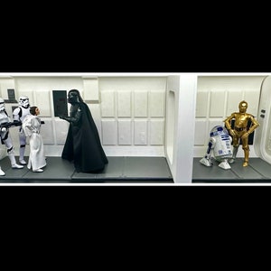 May include: A Star Wars action figure set featuring Darth Vader, Princess Leia, two Stormtroopers, R2-D2, and C-3PO. The figures are posed in a scene from the movie, with Darth Vader confronting Princess Leia and the Stormtroopers standing guard. R2-D2 and C-3PO are standing together in the background.