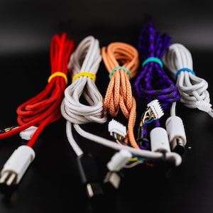 May include: Five different colored braided cables with connectors. The cables are red, white, orange, purple, and white. The connectors are all white.
