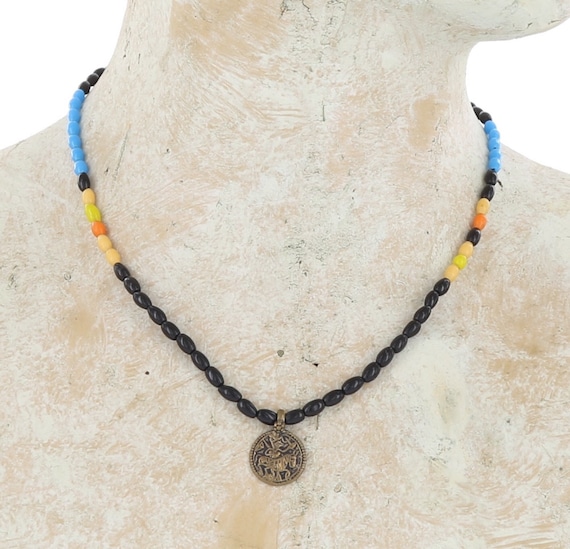 Vintage African beads necklace, antique glass trade beads in black, yellow,  and turquoise, with brass Hindu amulet, and brass lobster