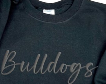 May include: Black sweatshirt with the word "Bulldogs" written in a stylized font.
