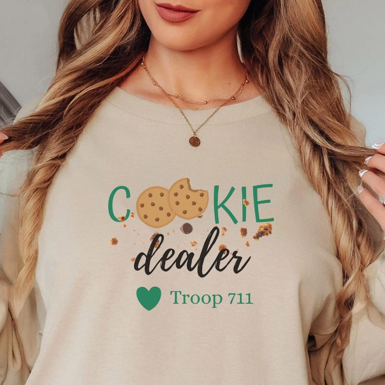 Cookie season sweatshirt with cookie illustrations and troop number detail. Soft cozy crewneck perfect for Girl Scout events, cookie booths, and everyday casual wear.