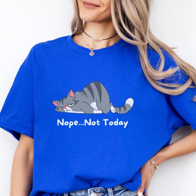 May include: A t-shirt with a cartoon gray cat lying down with the text 'Nope...Not Today' printed below the cat.