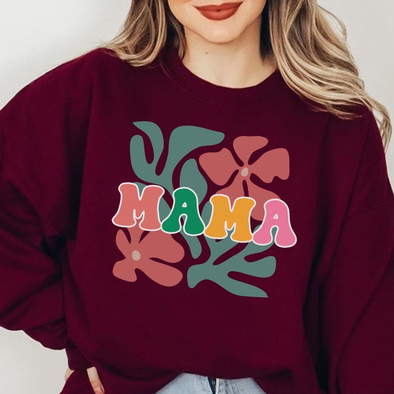 Mama graphic tee with retro floral design and colorful text, trendy mom t shirt for women, breathable soft fabric for everyday wear, perfect for casual outfits, lounging, and special occasion gifting.