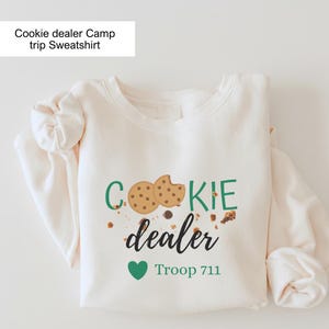Girl Scout cookie dealer crewneck with fun cookie design and troop customization. Comfortable sweatshirt ideal for scouts, scout moms, and cookie selling activities.