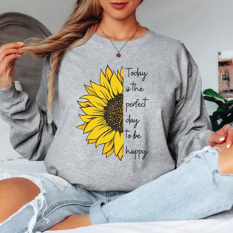 Sunflower sweatshirt featuring a bright floral design with Today is the perfect day to be happy quote printed on a gray crewneck. Inspirational shirt perfect for positive vibes, casual outfits, and everyday wear.