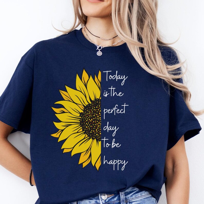 May include: A t-shirt with a yellow sunflower graphic and the text 'Today is the perfect day to be happy'.
