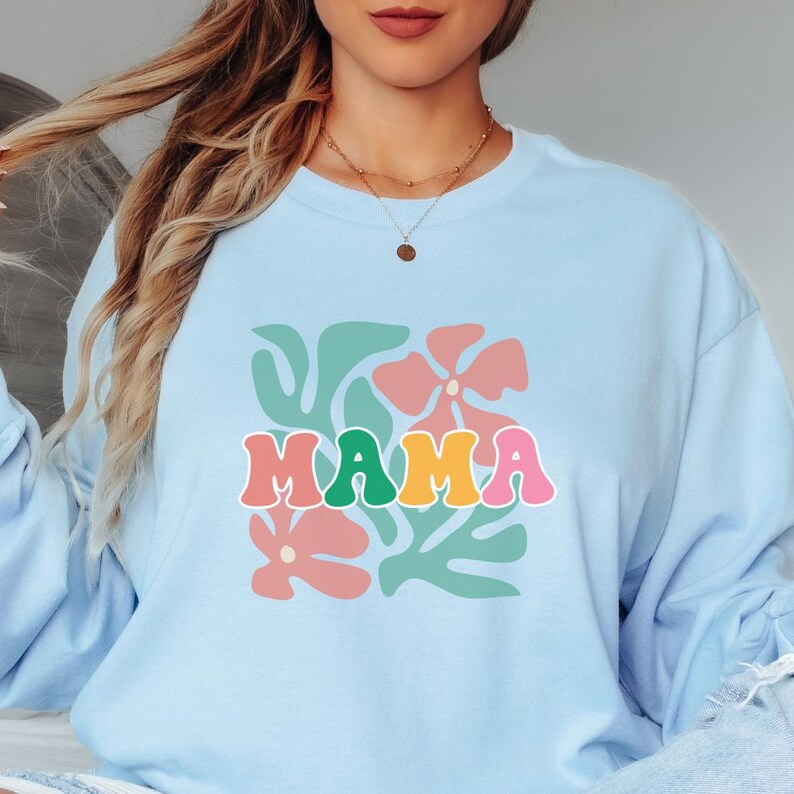 Floral mom shirt with mama text design, retro style graphic tee for women, soft lightweight material for everyday comfort, perfect for casual wear, family outings, and stylish mom outfits.