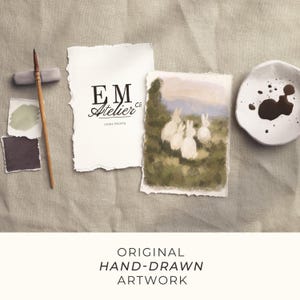 May include: A collection of original hand-drawn artwork. The image showcases a watercolour painting of white rabbits in a field, a paintbrush, paint swatches, and a small dish with dark liquid. The EM Atelier logo is also present.
