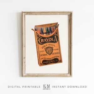 May include: Framed print featuring a vintage Crayola Gold Medal crayons box. The box is orange with black and gold lettering, and contains eight crayons in various colors. The print is labeled "DIGITAL PRINTABLE" and "INSTANT DOWNLOAD".
