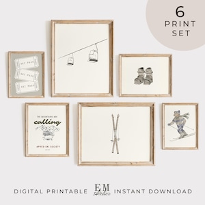 May include: A collection of six framed art prints with a winter sports theme. The prints depict a ski lift, ski boots, skis, a skier, and ski passes. The text "The mountains are calling" is also included. The prints are in neutral tones.