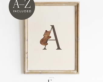 May include: A printable alphabet poster featuring a brown bear climbing the letter A. The poster is framed in a gold frame and has a white background.