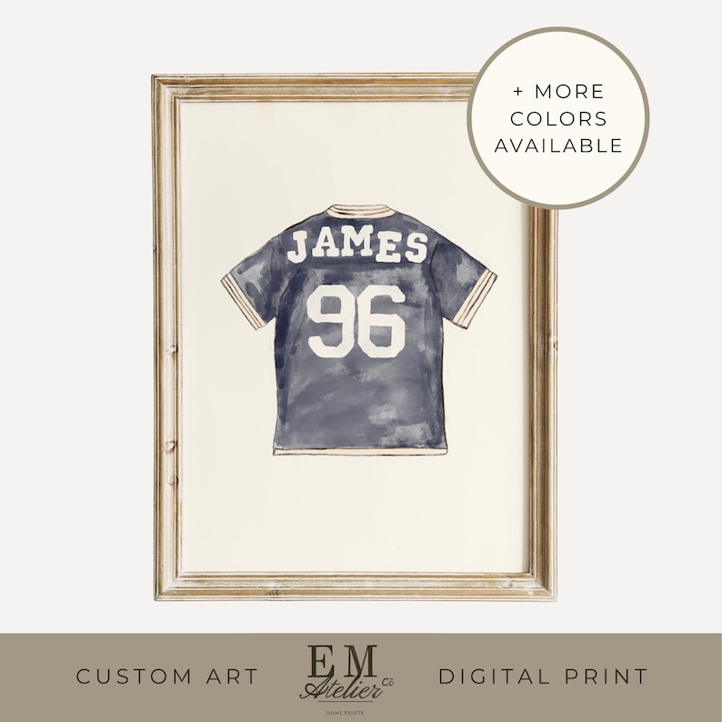 May include: Watercolor print of a navy blue jersey with the name "JAMES" and the number "96" in white. The artwork is framed in a light-colored wooden frame. Text on the image reads "+ MORE COLORS AVAILABLE", "CUSTOM ART", and "DIGITAL PRINT".