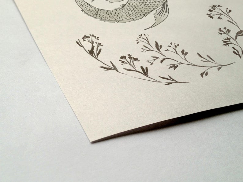 May include: A black and white illustration of a mermaid tail with a floral design around it. The background is a light beige.