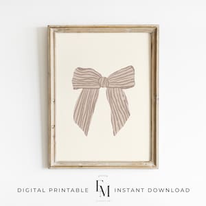 Elegant pink bow wall art for a vintage-inspired nursery or girl's bedroom.