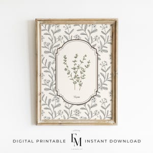 May include: A framed botanical print featuring a thyme illustration. The artwork has a beige background with a floral pattern in black and white. The thyme illustration is in a central oval, with the word "Thyme" below it.