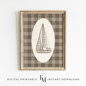 May include: A framed digital print featuring a sailboat illustration within an oval against a plaid background. The artwork is in neutral tones of beige, brown, and white, with the text "DIGITAL PRINTABLE INSTANT DOWNLOAD" at the bottom.