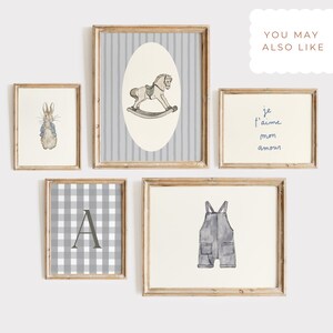May include: A collection of framed art prints with a nursery theme. The prints feature a rocking horse, a bunny, a gingham pattern with the letter "A", overalls, and the text "je t'aime mon amour". The frames are wooden.