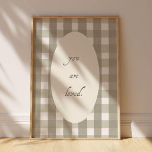 Gender neutral wall art with love quote and gingham pattern